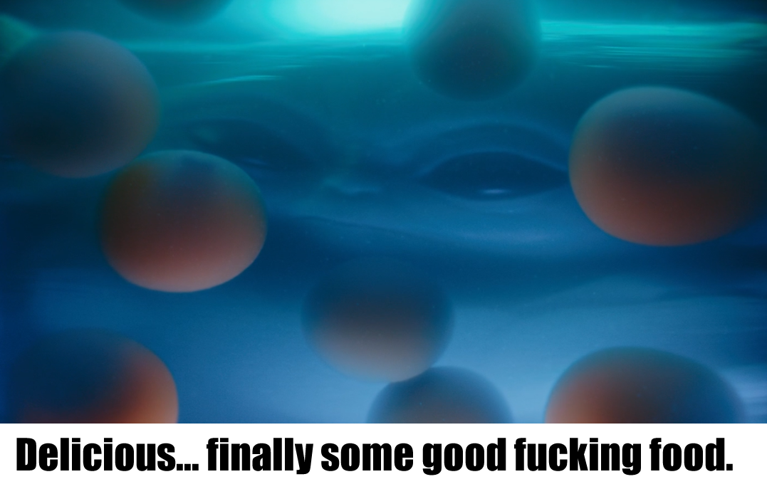 This meme is a humorous image of a person's face with a shocked expression, but the face is distorted and exaggerated to the point of being almost unrecognizable. The text overlayed on the image reads: "Delicious... finally some good food". The meme is likely poking fun at the idea that the person is so hungry that they're excited to eat something, even if it's not particularly good.